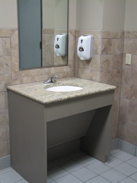 Commercial ADA vanity with removable panel for plumbing access in Austin, Texas.