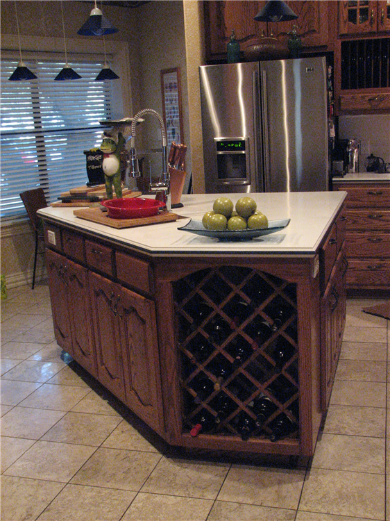 Custom Stained Oak Cabinets With Raised Panel Doors Below a Solid Surface Top