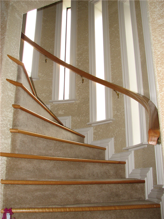 A True Half Round Stair Well With Curved Window Sills and Oak Stair Nosing and Rail