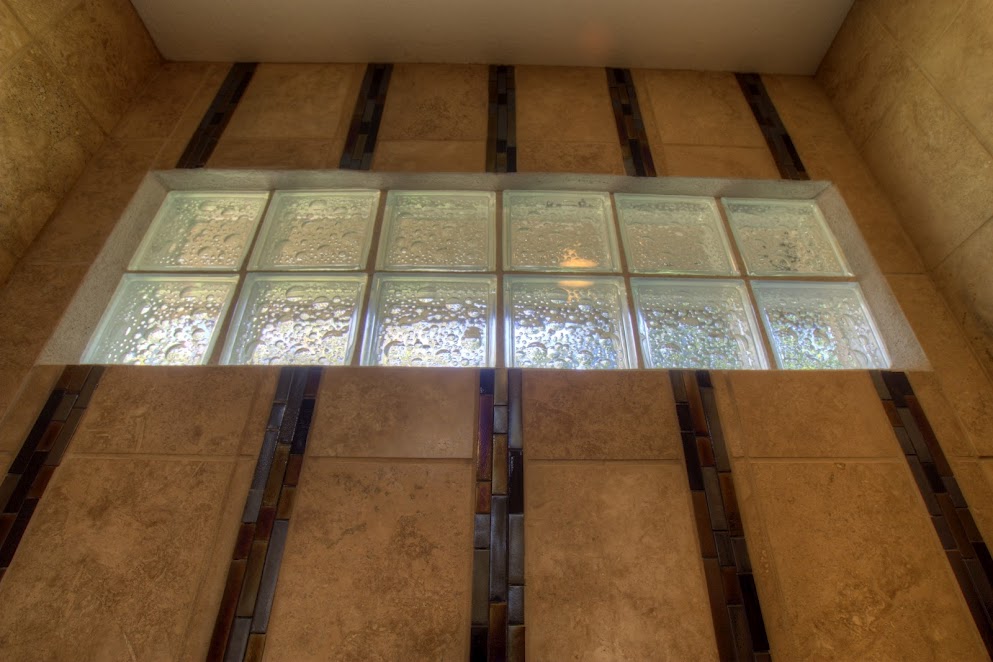 Travertine marble accented with glass tiles and blocks